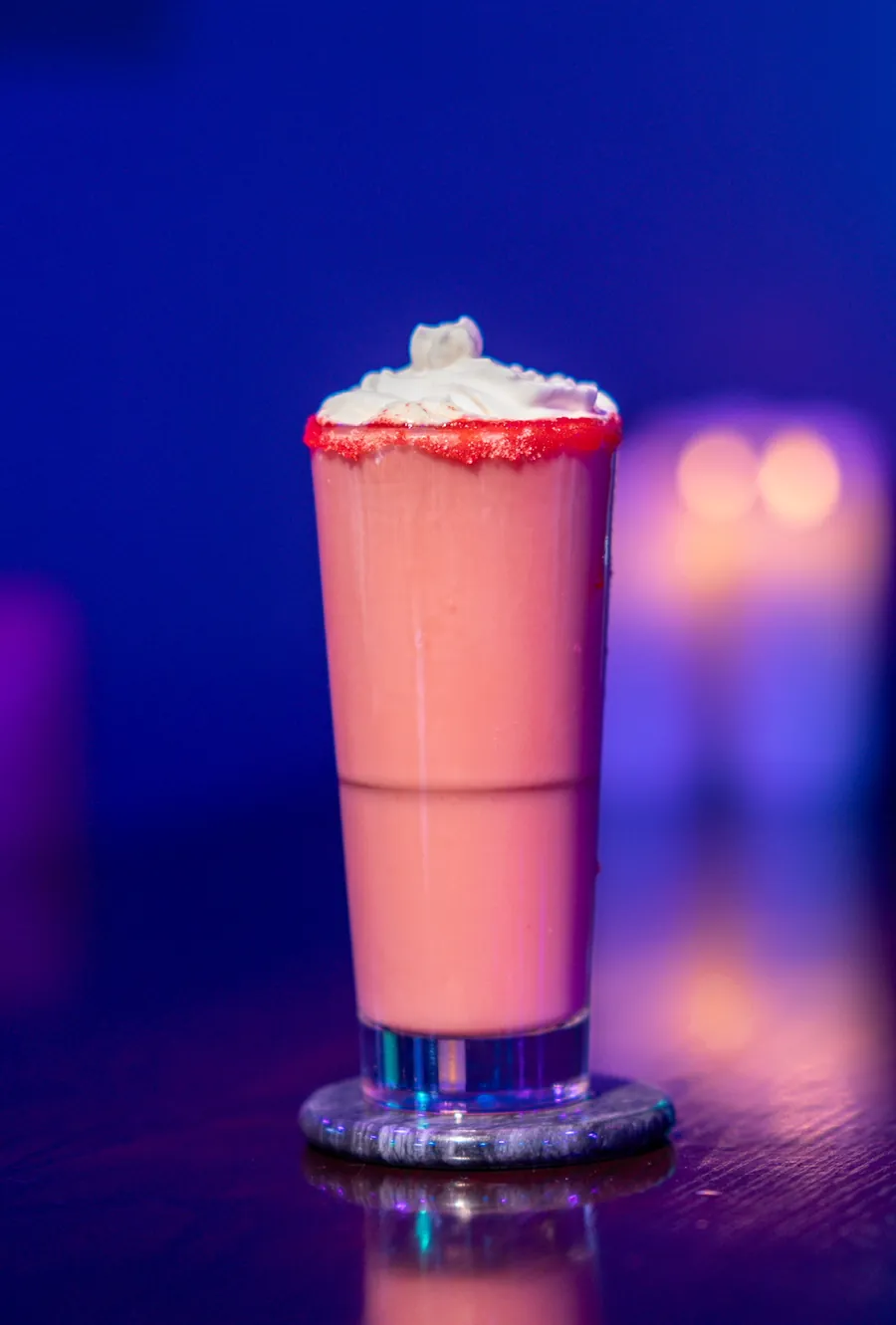 Strawberry Shortcake kava mocktail with whipped cream and a red sugar rim at Decades Kava in Longwood, FL